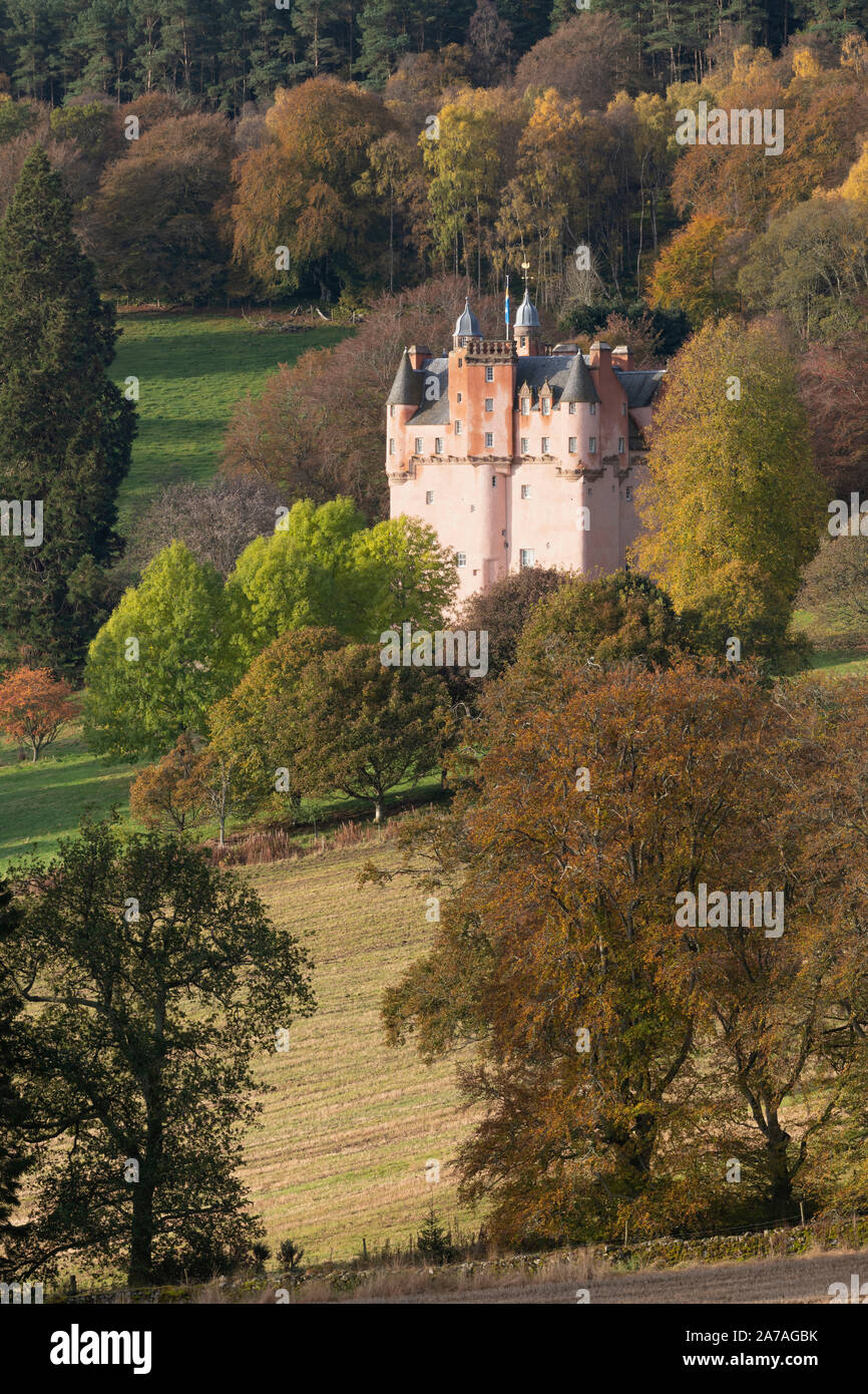 Craigievar Castle in Aberdeenshire Sitting on a Hillside Amongst Trees Displaying Their Various Autumn Colours Stock Photo