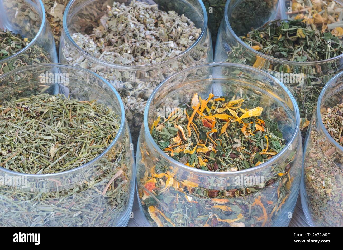 Set of various herbs. Herbal teas in jars on a wooden table. Stock Photo