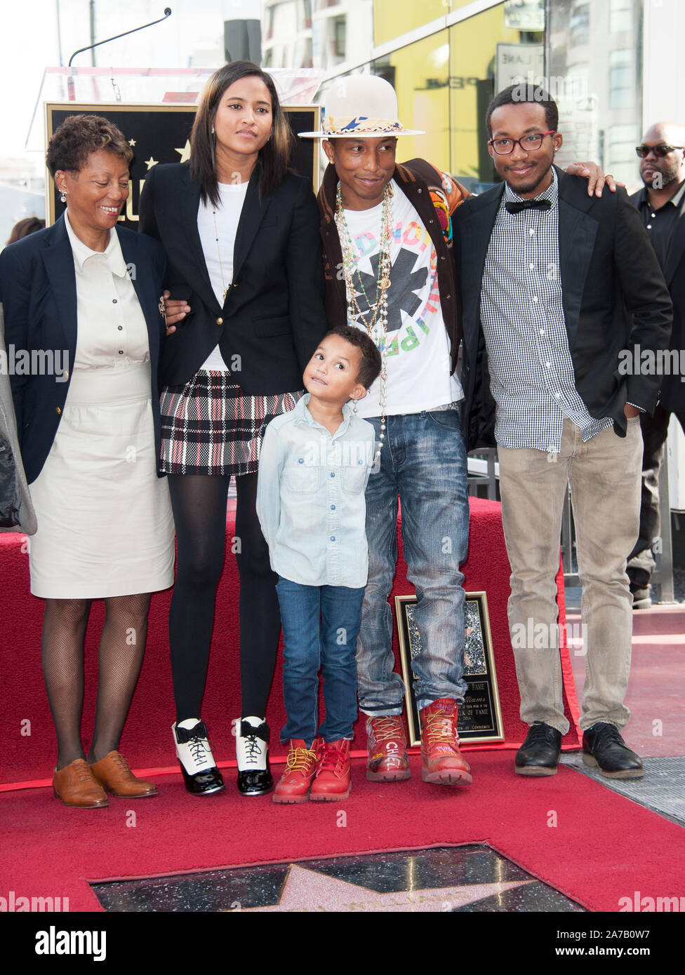 LOS ANGELES, CA - DECEMBER 4, 2014: Singer/songwriter Pharrell Williams  with wife & son & family on Hollywood Boulevard where he was honored with  the 2,537th star on the Hollywood Walk of