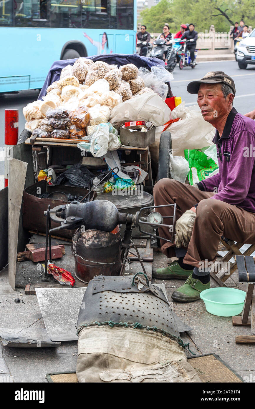 Elderly man making snacks traditional method Stock Photo - Alamy