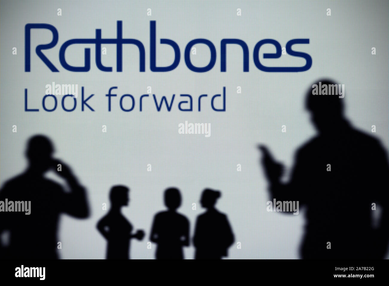 The Rathbone Brothers logo is seen on an LED screen in the background ...
