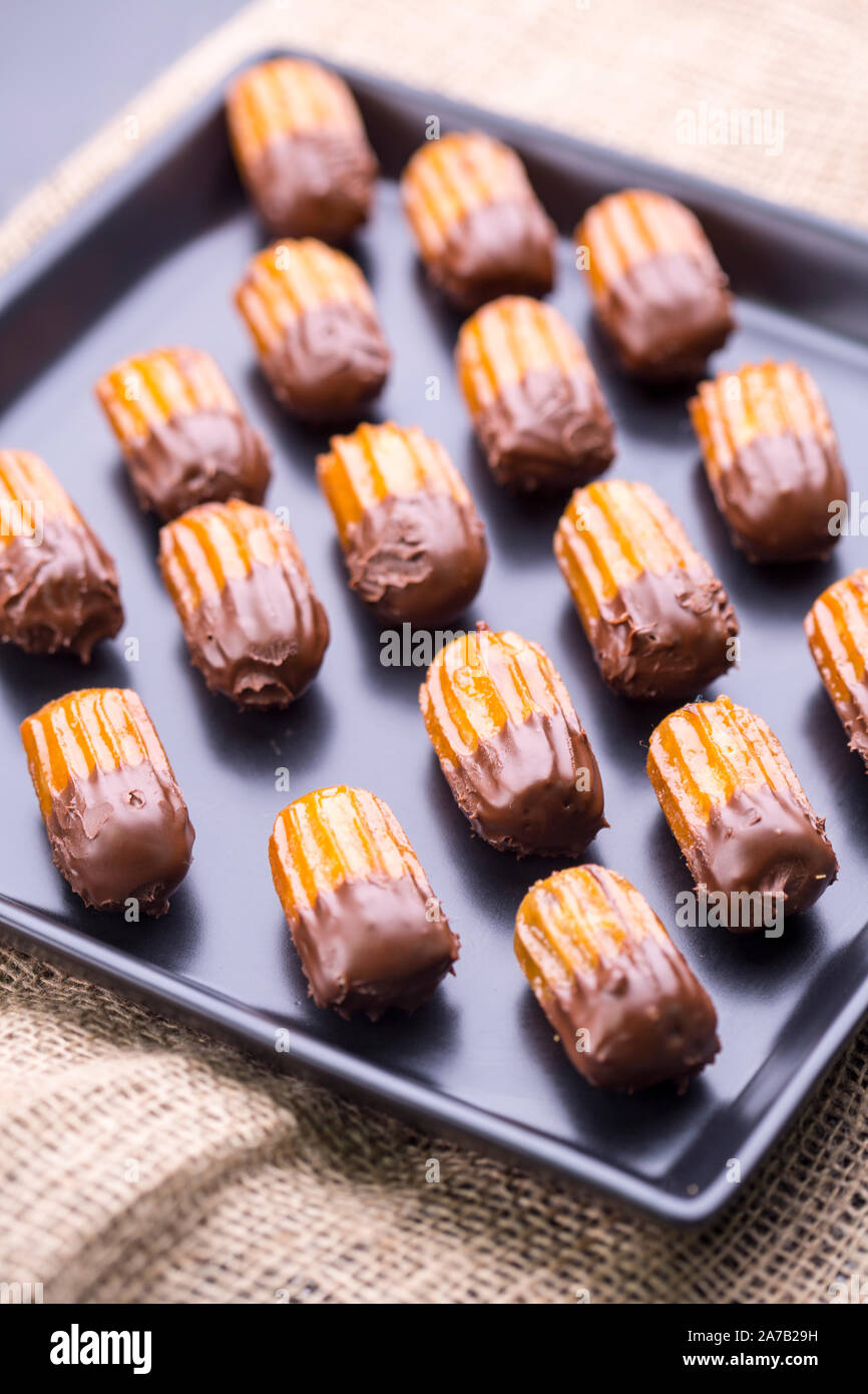 Oriental fritter dessert  dipped in chocolate ganache Stock Photo