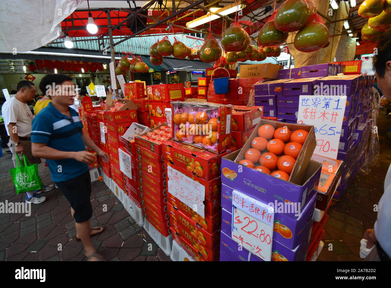 Outdoor market stalls sellers selling Lunar Chinese New Year food fruits. Translation "Fresh
