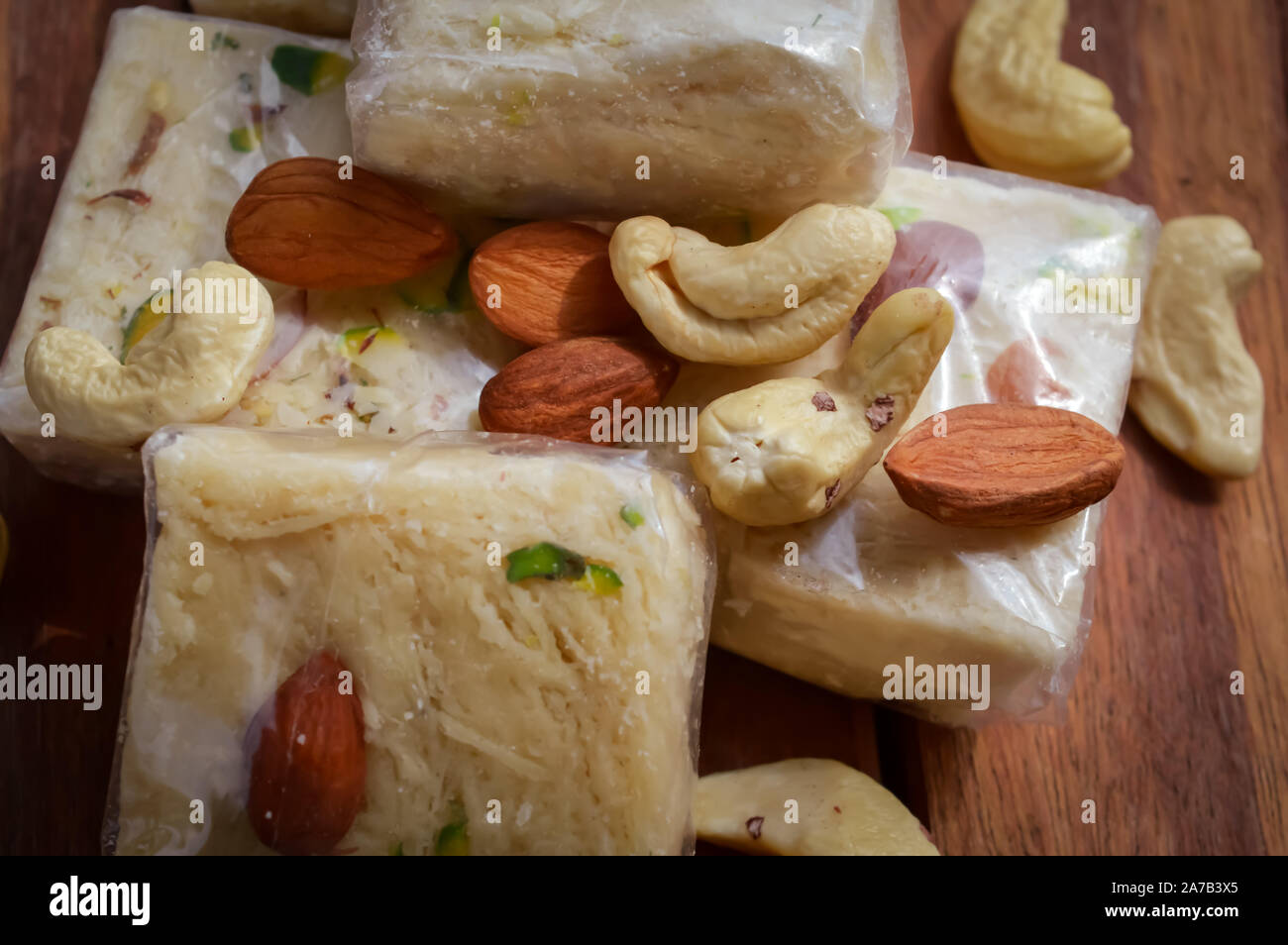 sonpapdi and nuts on wooden table,soanpapdi top view Stock Photo