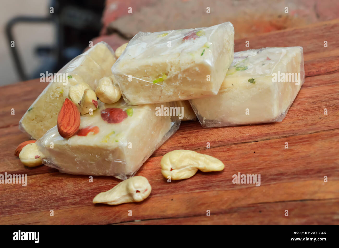 India Papdi and nuts on wooden table,soan Papdi indian sweet on wooden table Stock Photo