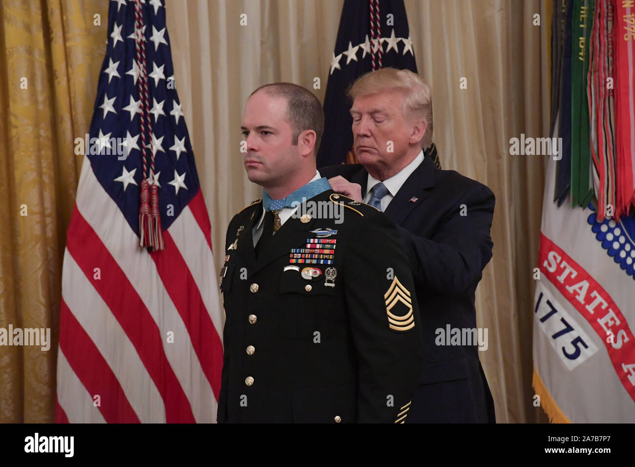 President Donald J. Trump presents the Medal of Honor to U.S. Army Master Sgt. Matthew O. Williams during a ceremony at the White House in Washington, D.C., Oct. 30, 2019. Williams was awarded the Medal of Honor for his actions while serving as a weapons sergeant with the Special Forces Operational Detachment Alpha 3336, Special Operations Task Force-33, in support of Operation Enduring Freedom in Afghanistan on April 6, 2008. (U.S. Army Photo by Sgt. Keisha Brown) Stock Photo