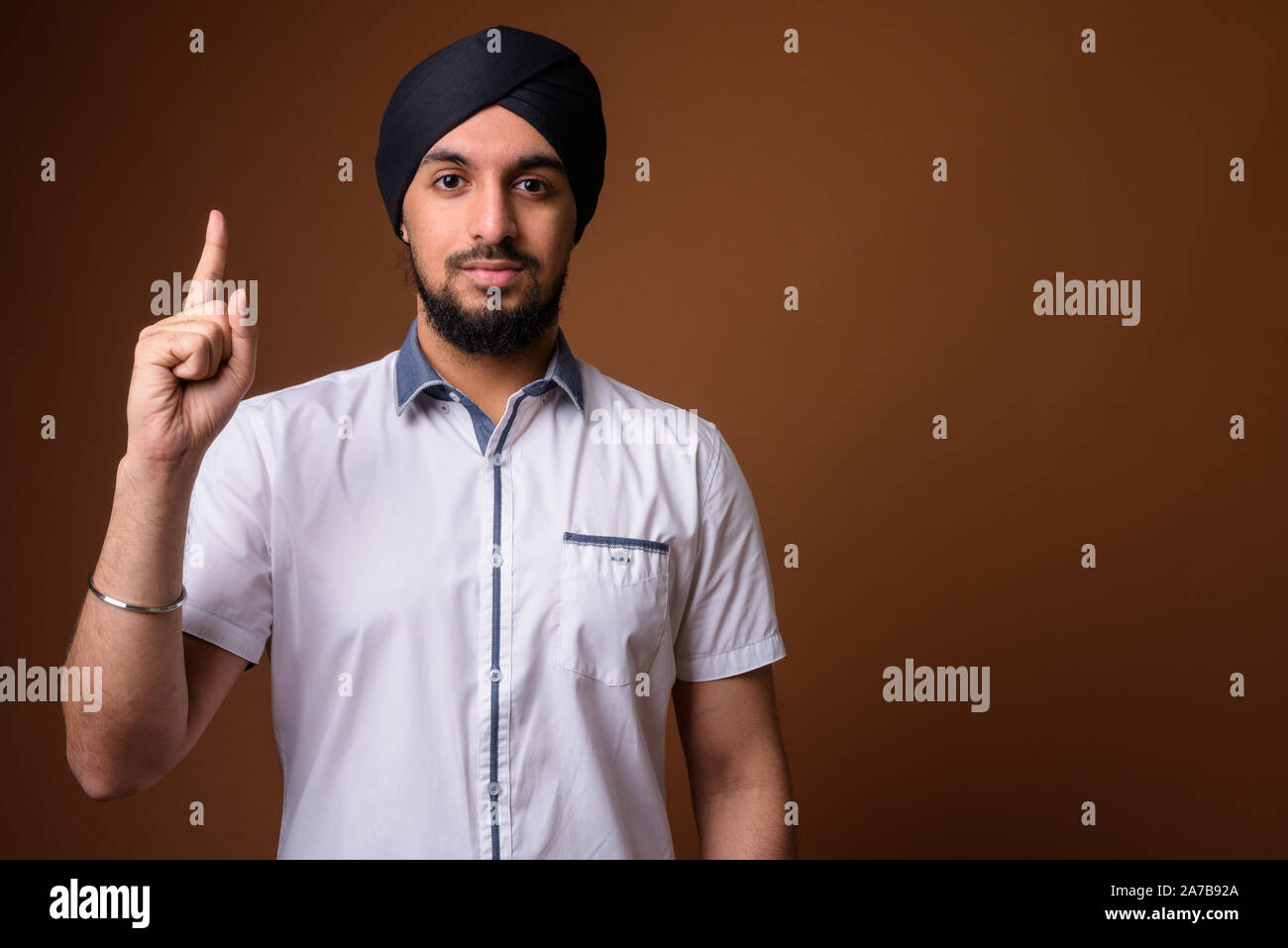 Young bearded Indian Sikh man wearing turban Stock Photo