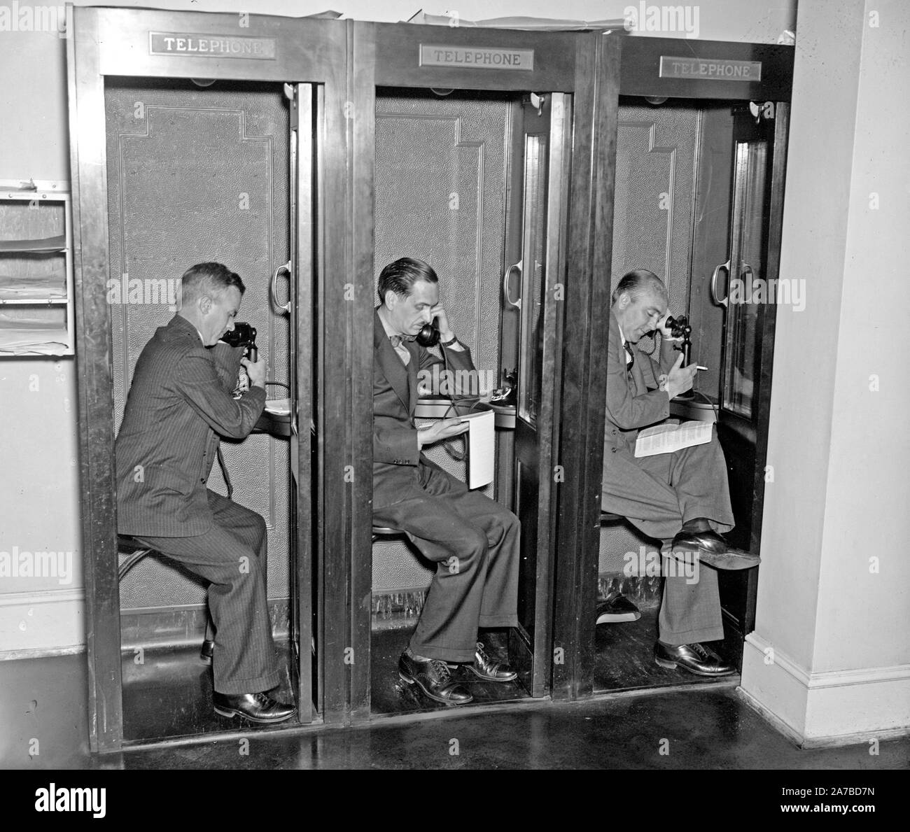 Reporters in White House press room calling in their stories to newspaper editors  ca. 1937 Stock Photo