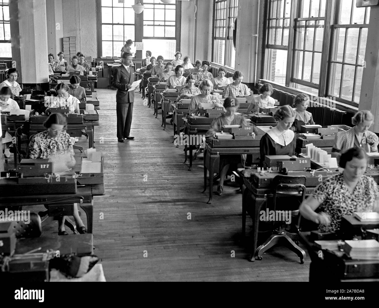 Social Security Board Records Office -  Workers at work in part of the key machine section, where master cards are punched ca. 1937 Stock Photo