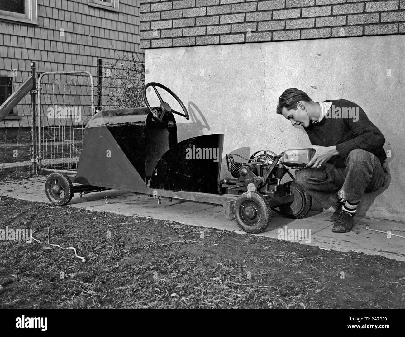 16 year old boy with his home made go kart powered by a washing machine motor ca. 1939 Stock Photo