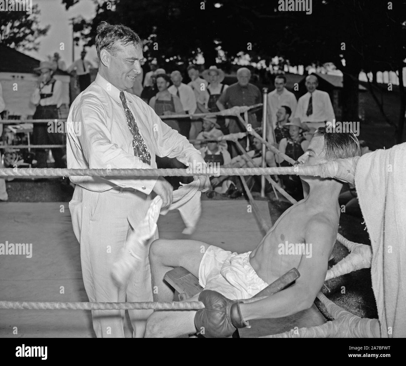 Trainer trying to revive boxer as he rests on his stool between rounds ca. 1937 or 1938 Stock Photo