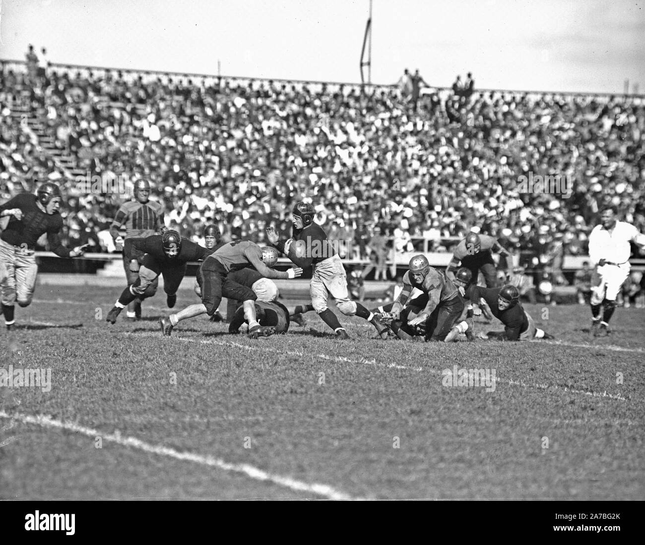 Running back Sneed Schmidt drives through the line in Navy's 18-6 defeat of William Mary to open the 1936 football season Stock Photo