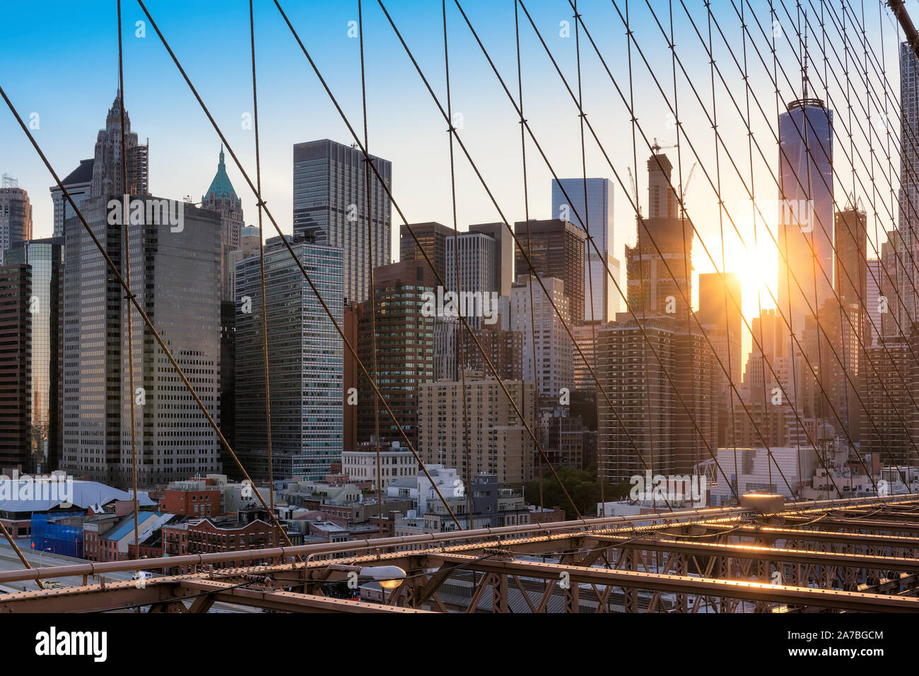 Manhattan skyline from Brooklyn Bridge at sunset in New York City, USA ...