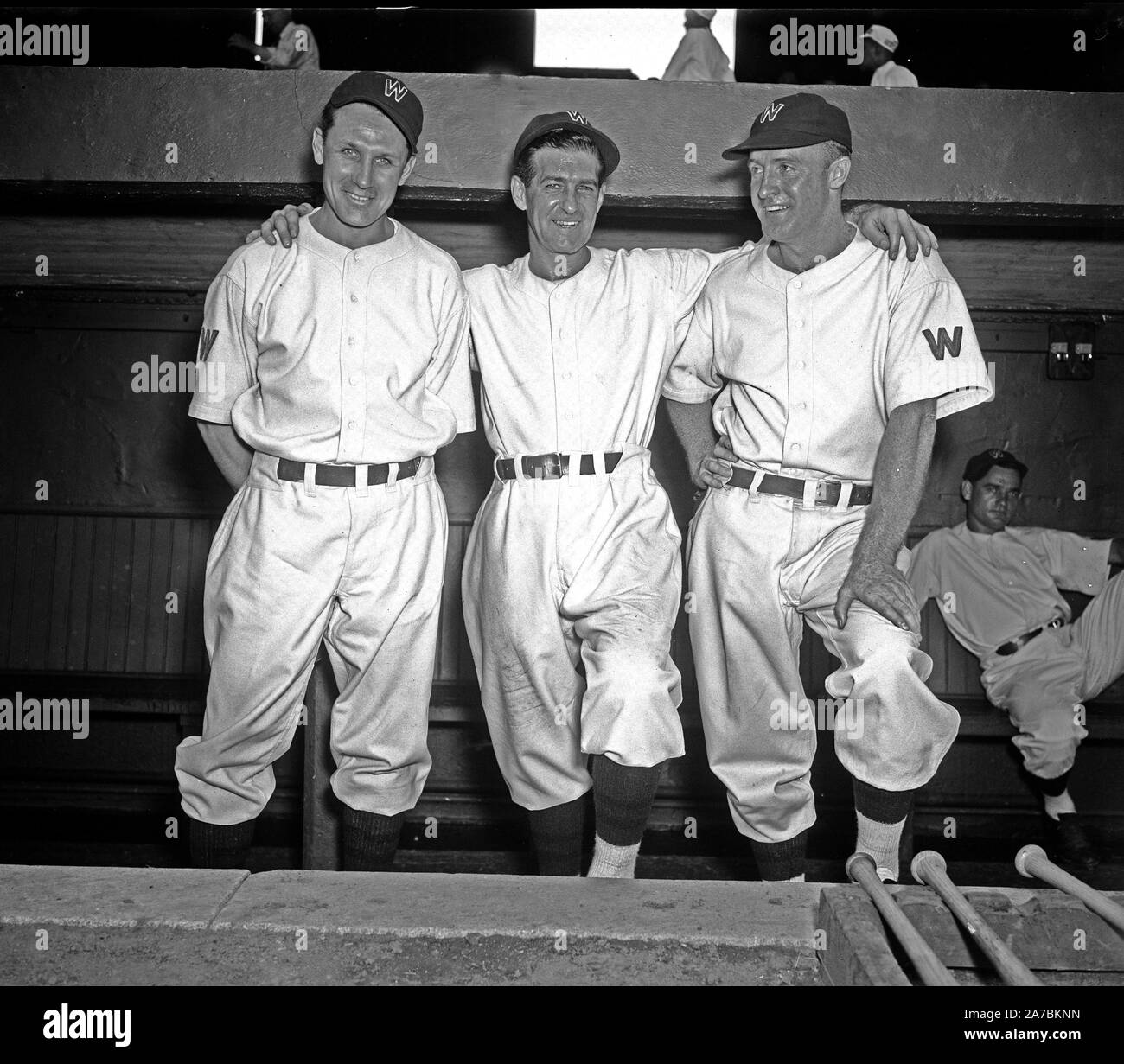Three Washington Baseball players (or coaches) standing on dug out steps ca. 1936 Stock Photo