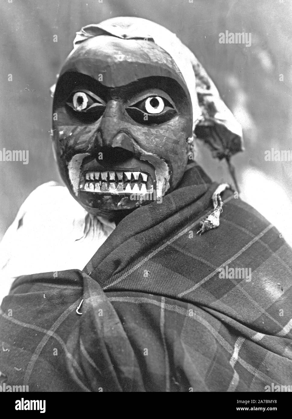 Ceremonial mask worn by a dancer portraying the hunter in Bella Bella mythology who killed the giant man-eating octopus. The dance was performed during Tluwulahu, a four day ceremony prior to the Winter Dance. Stock Photo