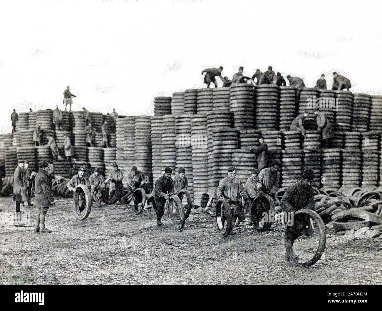 85,000 tires (Solid), for A.E.F. vehicles. 20,000 of these tires, weighing in some sizes 400 lbs., were handled in one week at this depot. German prisoners can be seen piling these up and putting them in sizes. Langres, Haute Marne, France Stock Photo