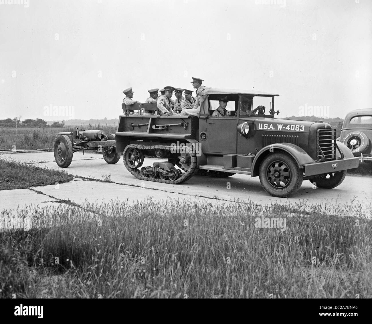 Half-track type military vehicile pulling a large gun ca. 1936 Stock Photo