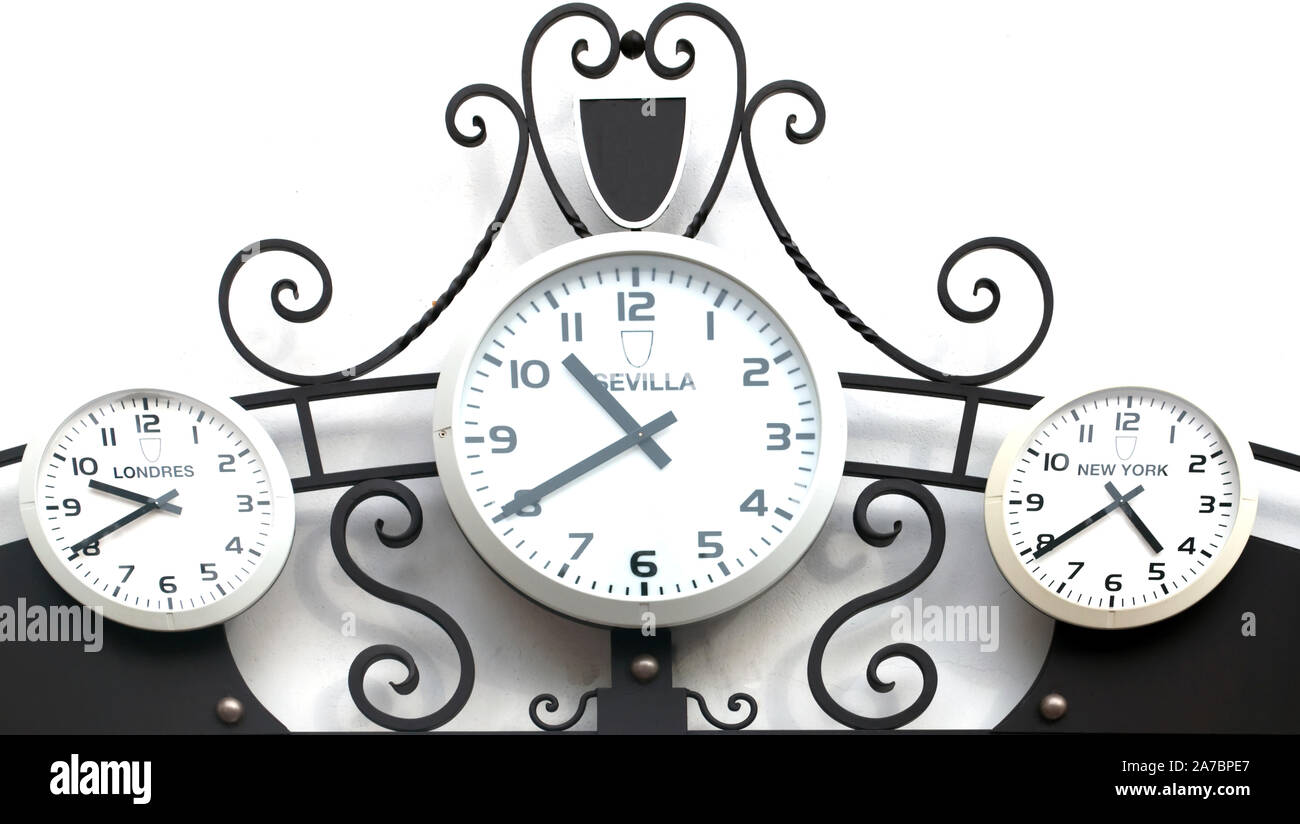 Three clocks next to each other marking the time in different cities