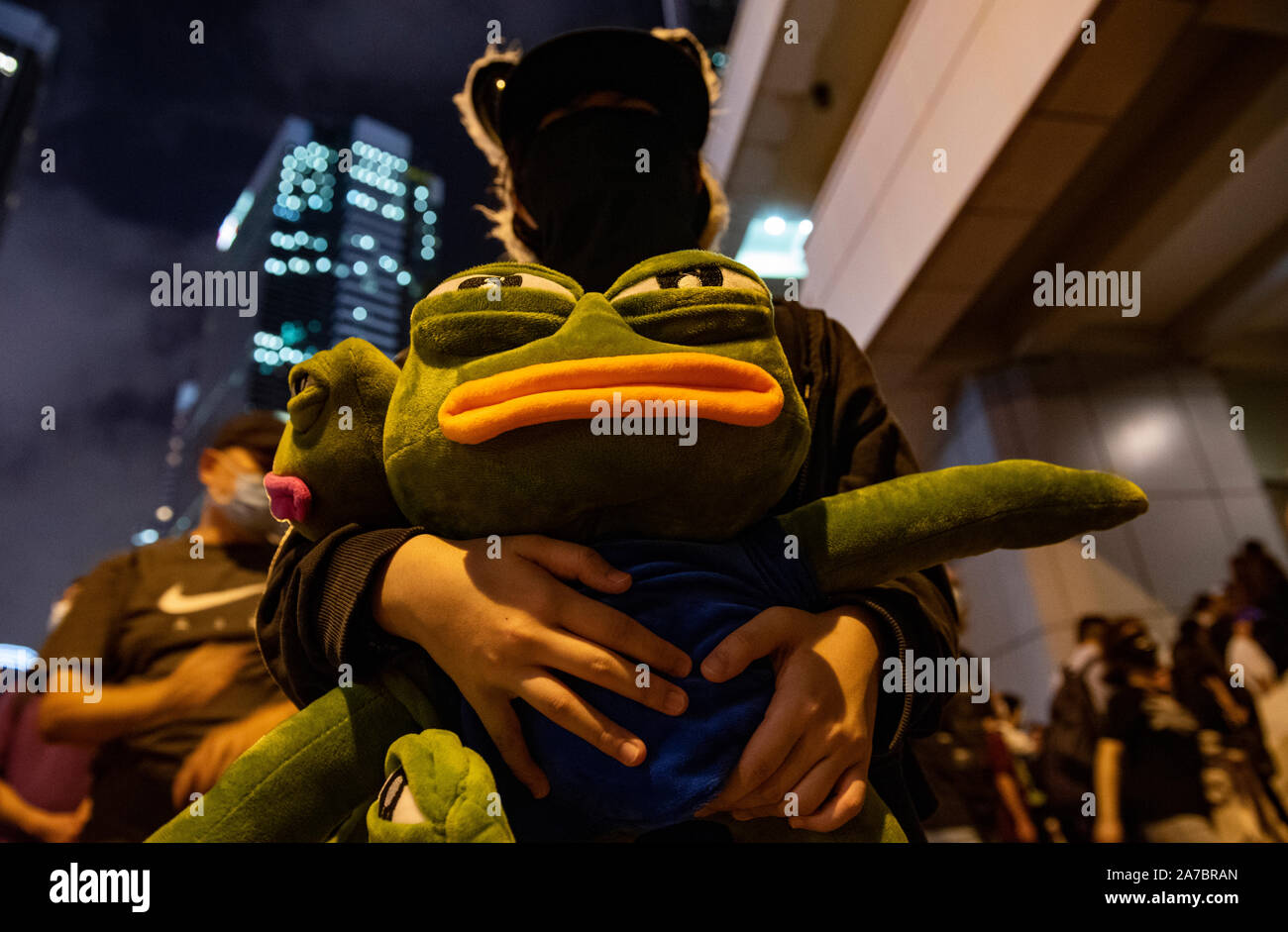 Hong Kong, China. 31st Oct, 2019. A protester holds a Pepe the frog toy ...