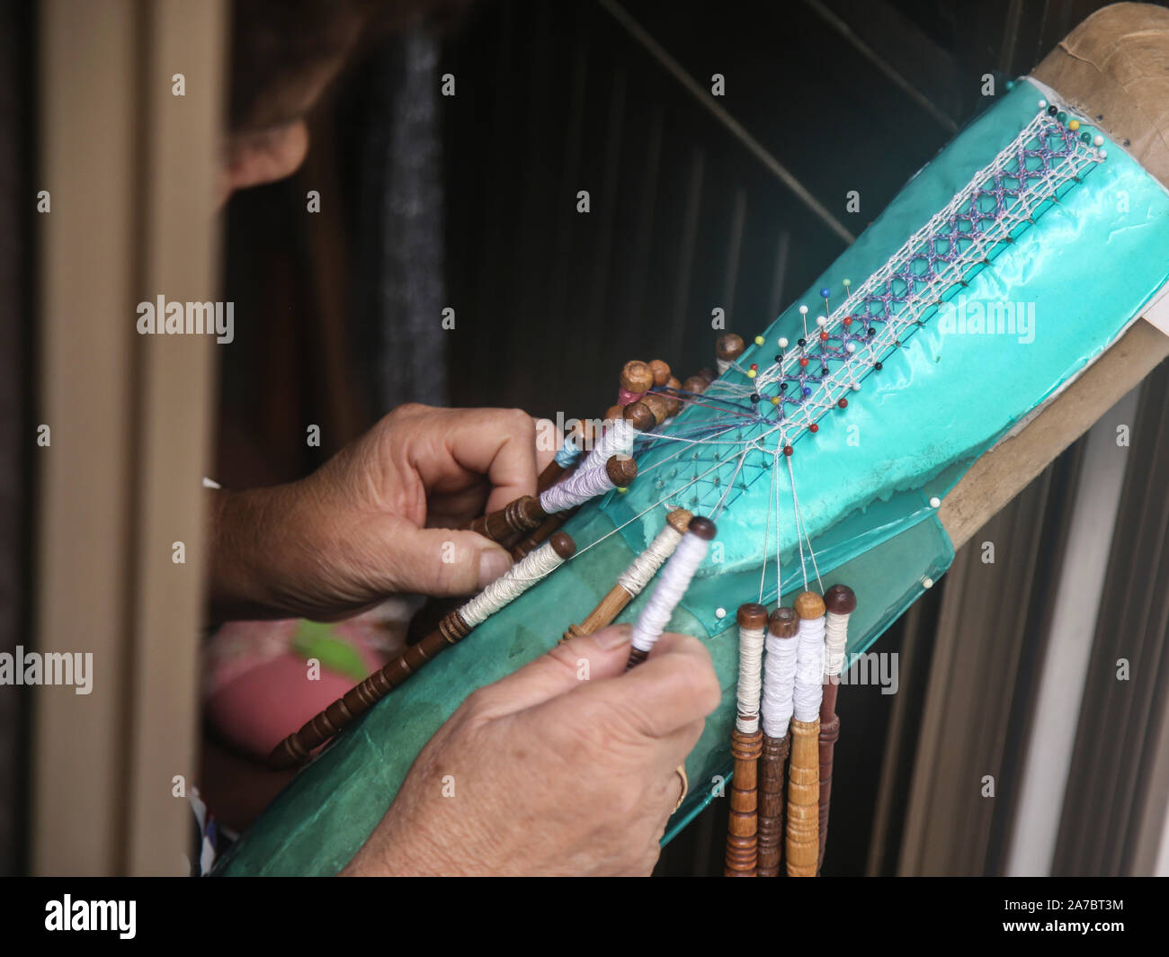 Woman doing craft with lace on Gozo Stock Photo