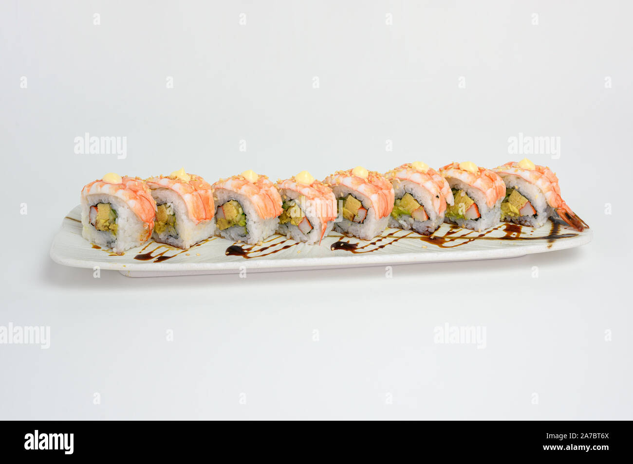 Shrimp or Ebi Japanese sushi roll with kani, tamago and teriyaki sauce on  ceramic plate Stock Photo - Alamy