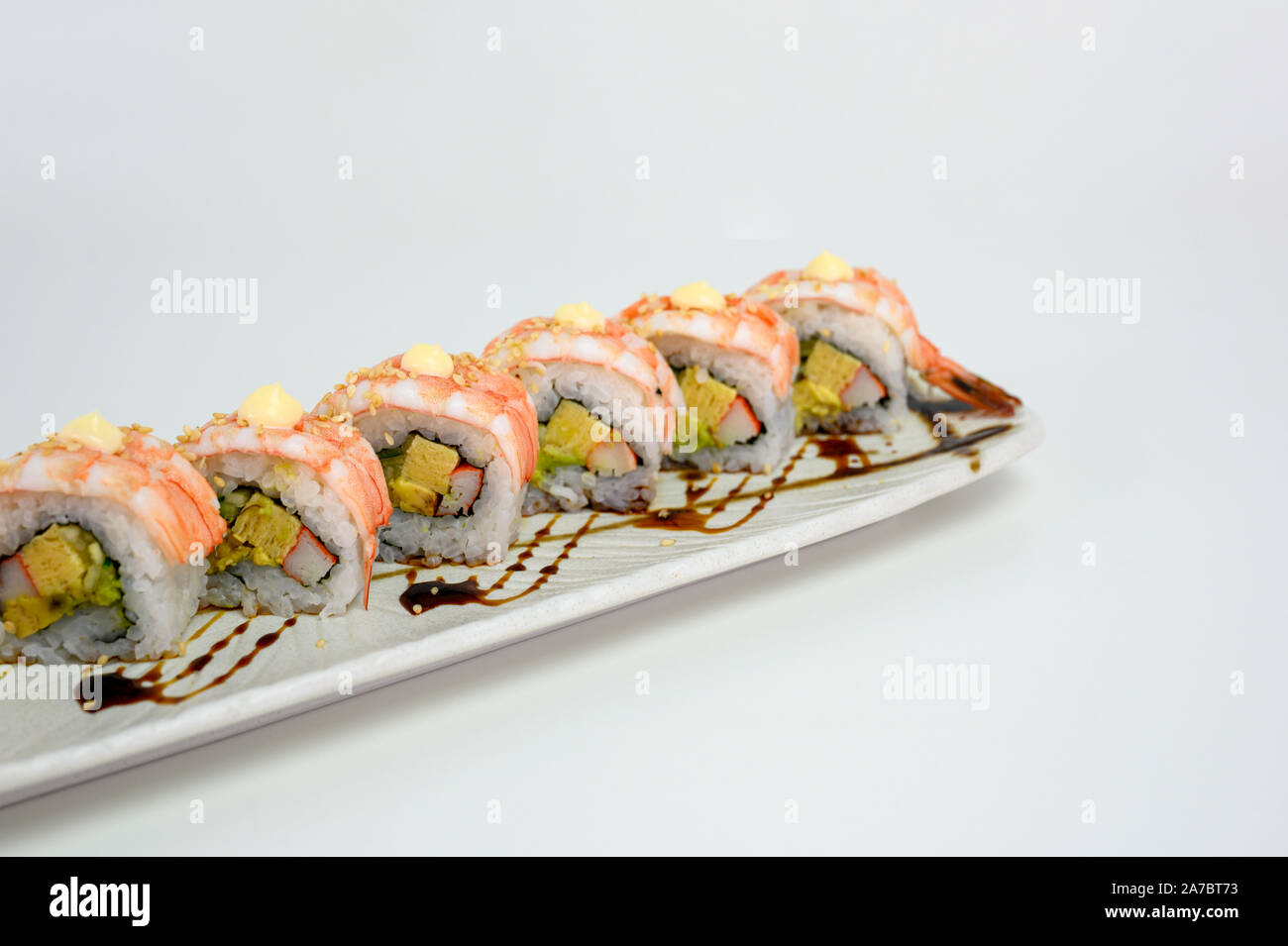 Shrimp or Ebi Japanese sushi roll with kani, tamago and teriyaki sauce on  ceramic plate Stock Photo - Alamy