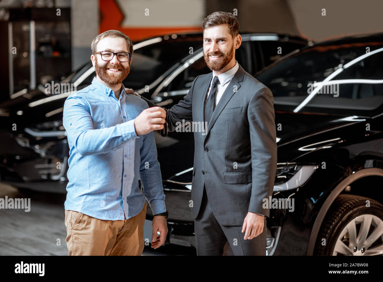 Key Car Dealership >> Sales Consultant Handing Car Keys To The Client At The Car Key Car Dealership >> Sales Consultant Handing Car Keys To The Client At The Car