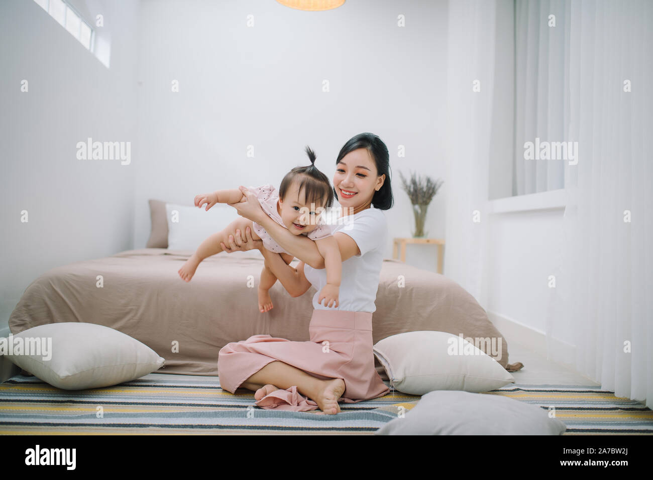 portrait of asian mother and baby relaxing in the room Stock Photo