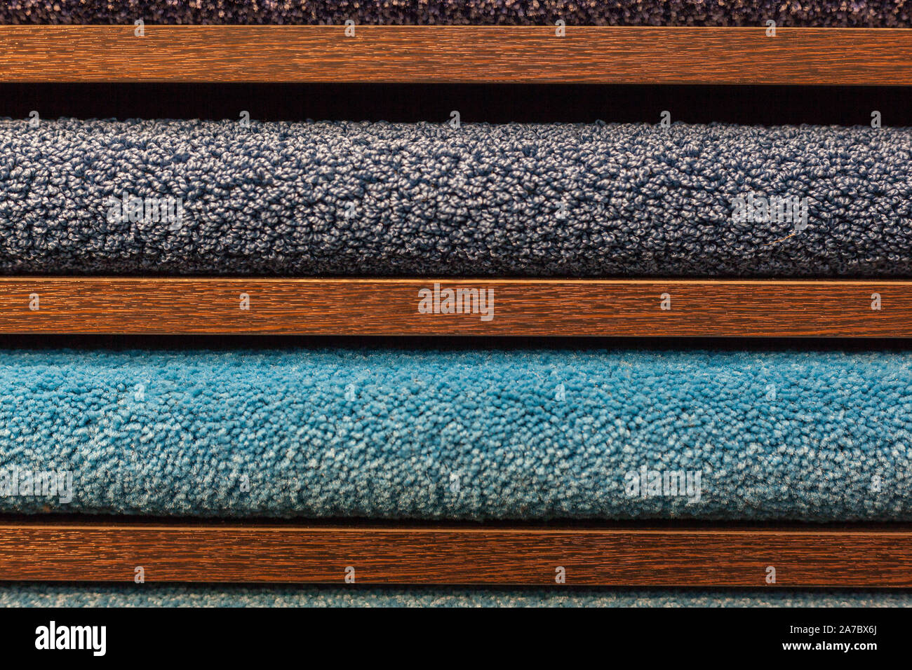 samples of multi-colored carpets on the shelves Stock Photo