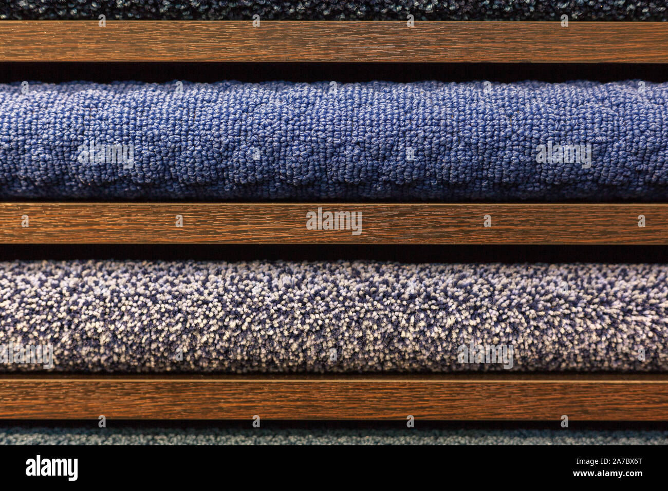 samples of multi-colored carpets on the shelves Stock Photo