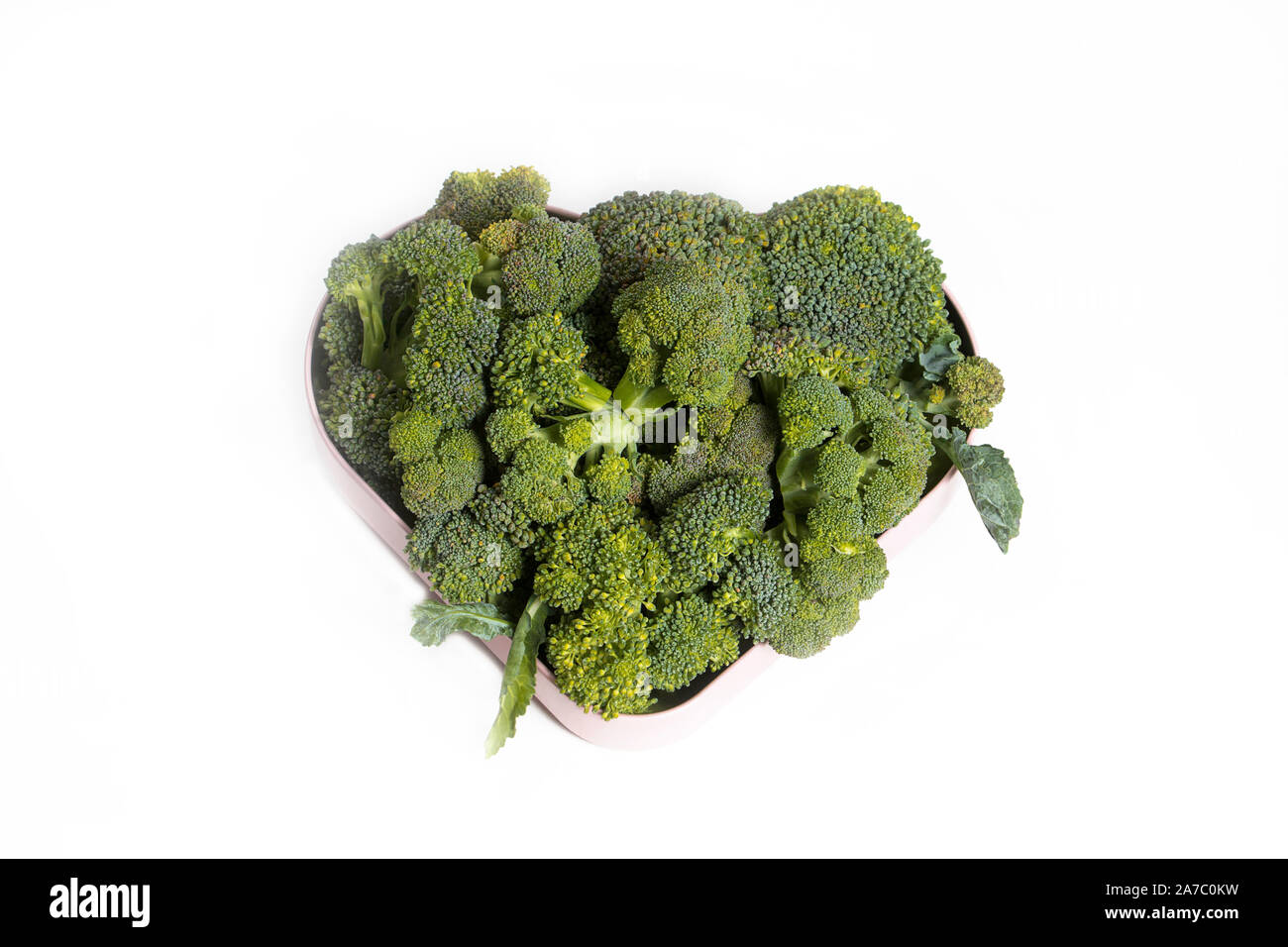 fresh broccoli broccoli in a bowl close up and leaves on a white background Stock Photo