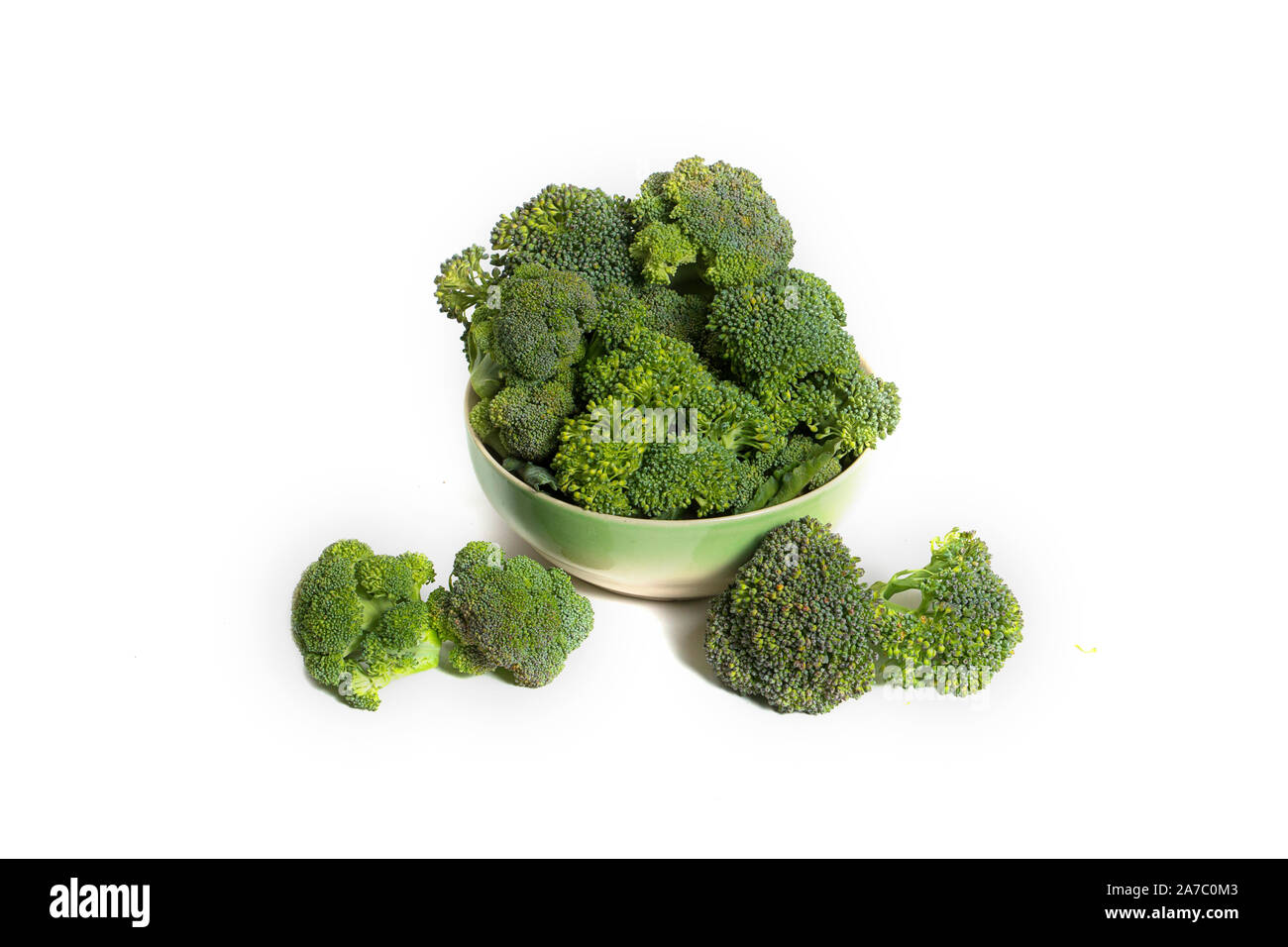 fresh broccoli broccoli in a bowl close up and leaves on a white background Stock Photo