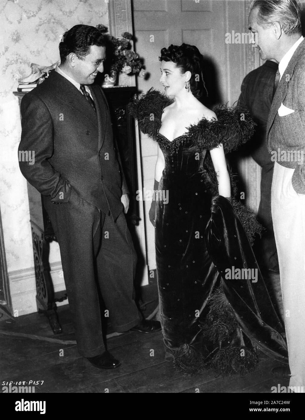 Producer DAVID O. SELZNICK VIVIEN LEIGH as Scarlett O'Hara in red dress and  Director VICTOR FLEMING on set candid during filming of GONE WITH THE WIND  1939 director Victor Fleming novel Margaret