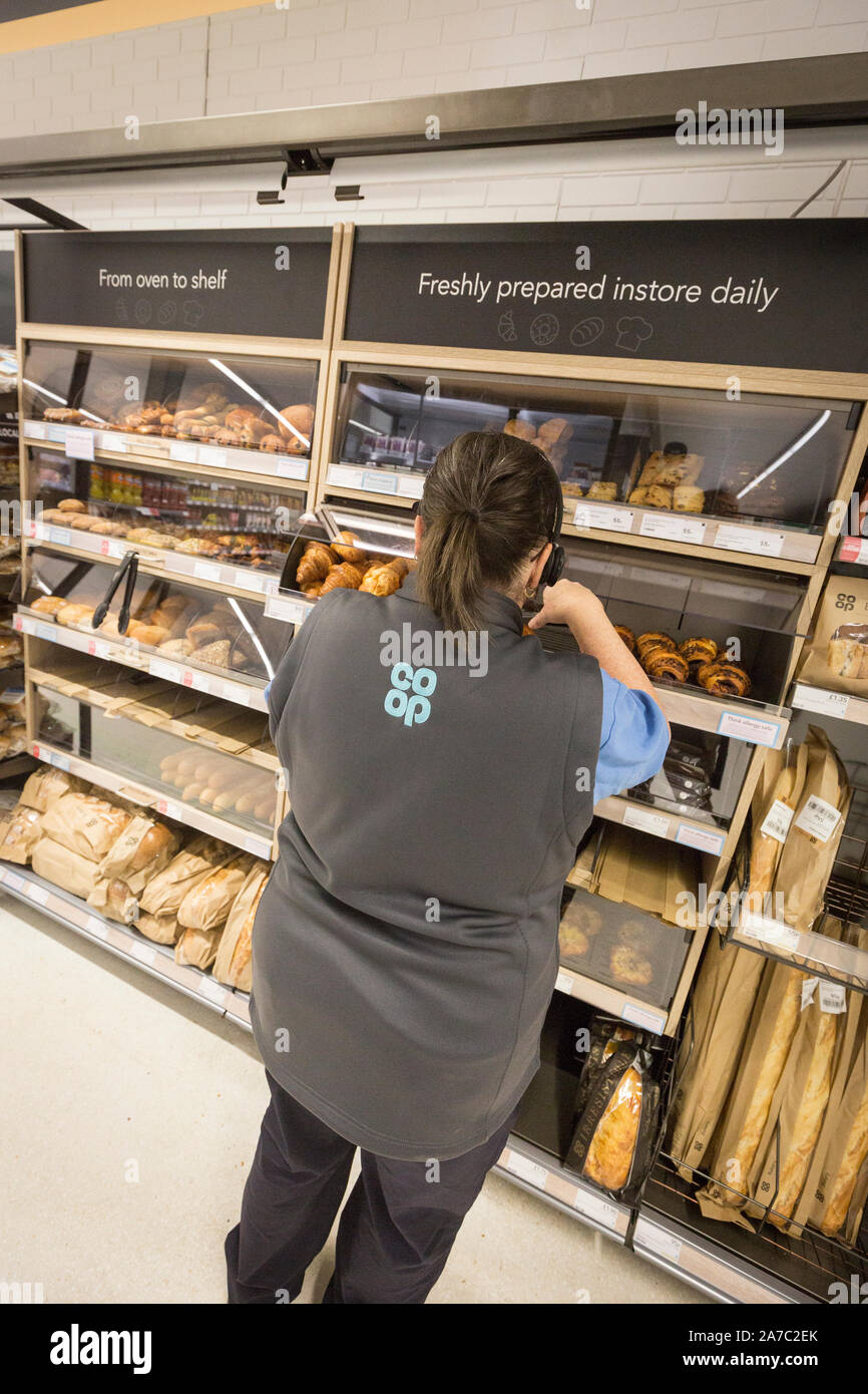 Pictures at a CoOp food store. A woman stacks shelves inside a CoOp