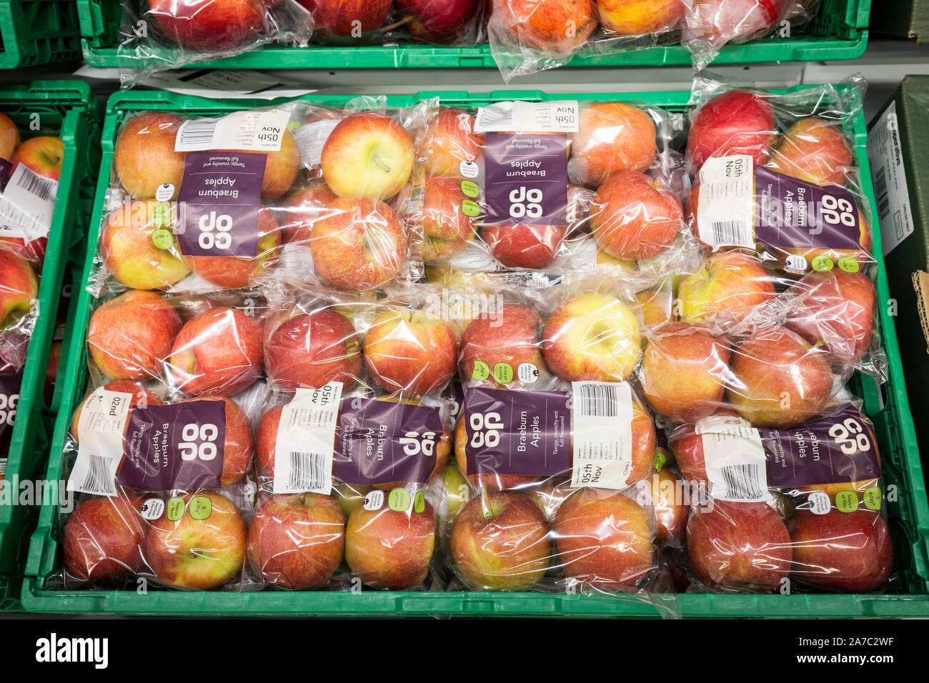 Pictures at a Co-Op food store. Braeburn apples in plastic bags. Stock Photo