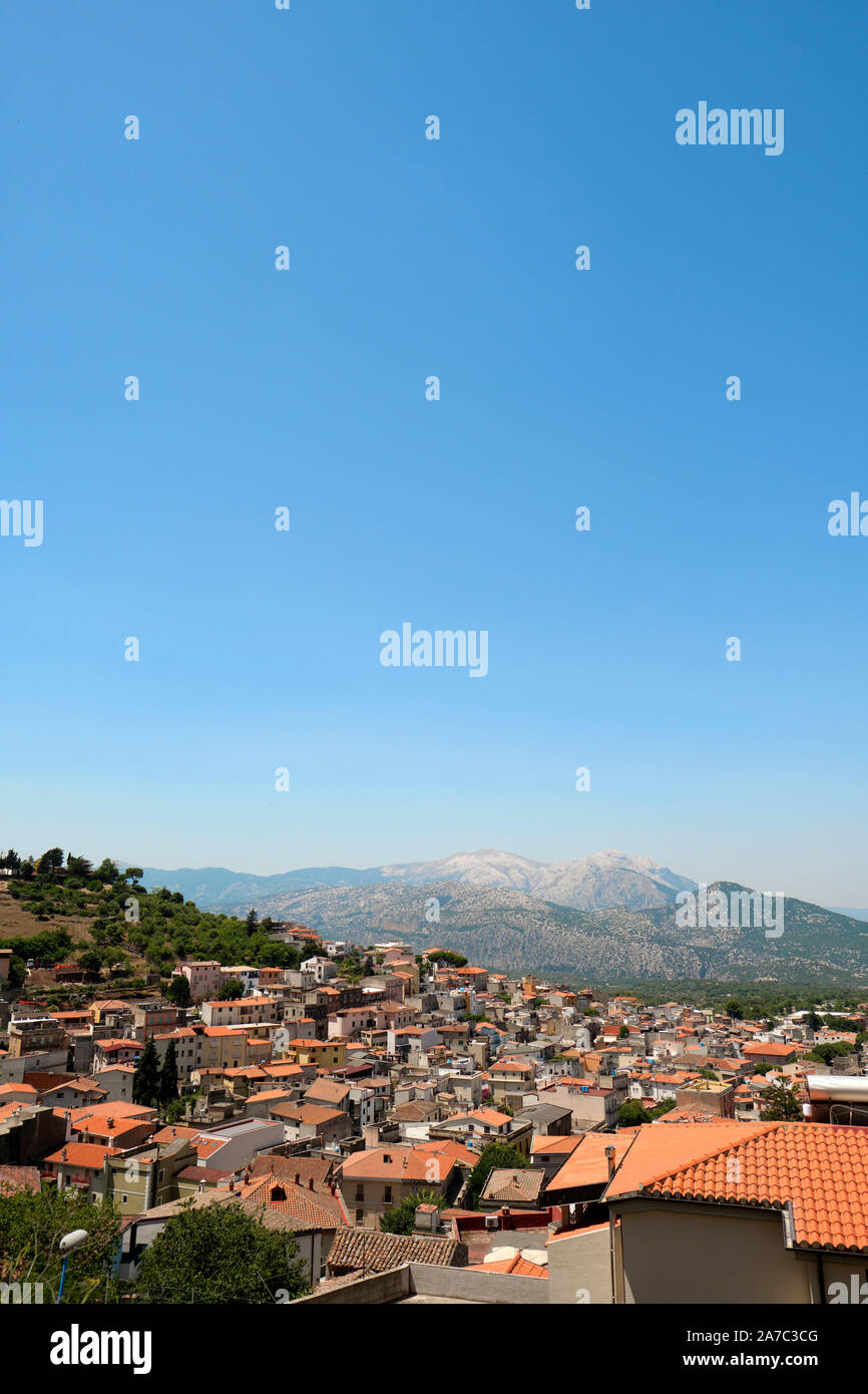 The rooftops of Dorgali town and the Supramonte mountain range landscape of the rural countryside of Nuoro province in Sardinia Italy Europe Stock Photo