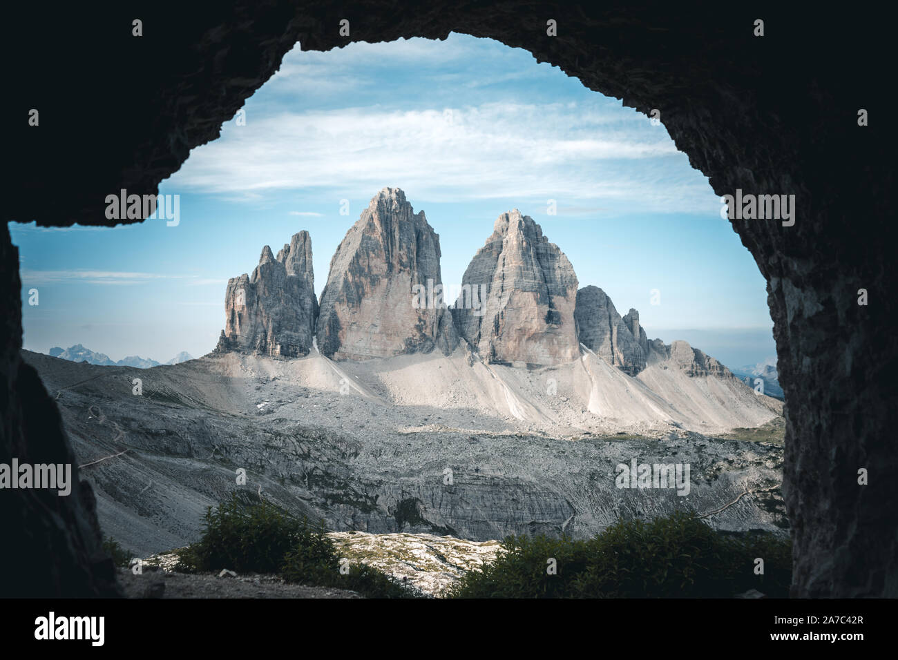 tre cime di (three peaks of) lavaredo peaks as seen from inside a cave where soldiers use to sleep during the second or first world war Stock Photo