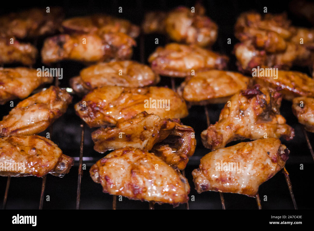 homemade spicy marinated chicken wings and wing stick on barbecue (BBQ