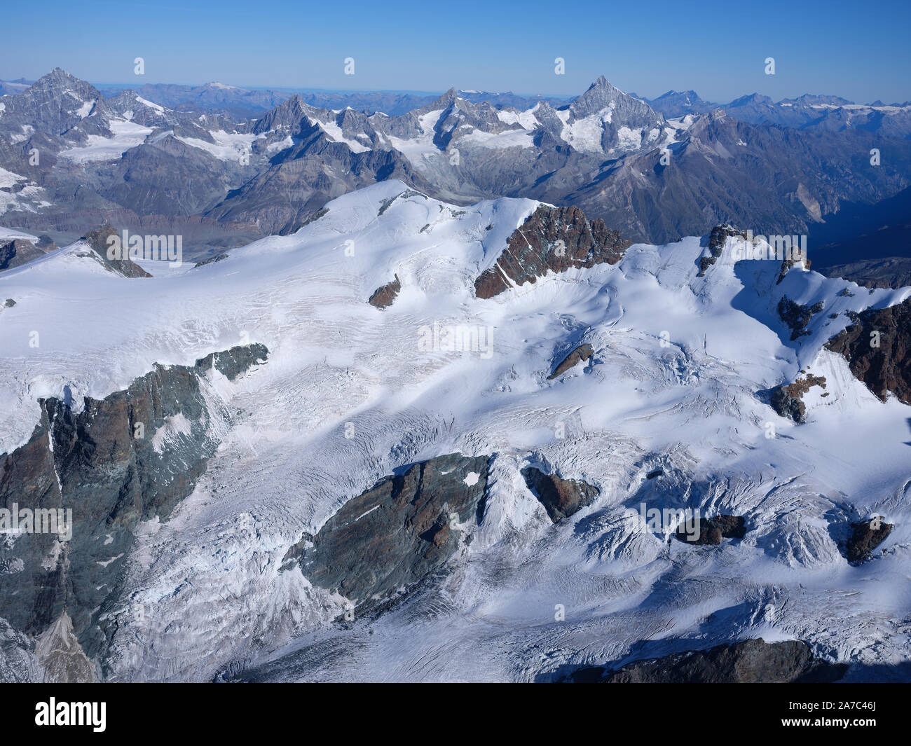 AERIAL VIEW. Italian side of 4164m-high Breithorn and 4506m-high Weisshorn in the distance. Aosta Valley, Italy & Canton of Valais, Switzerland. Stock Photo