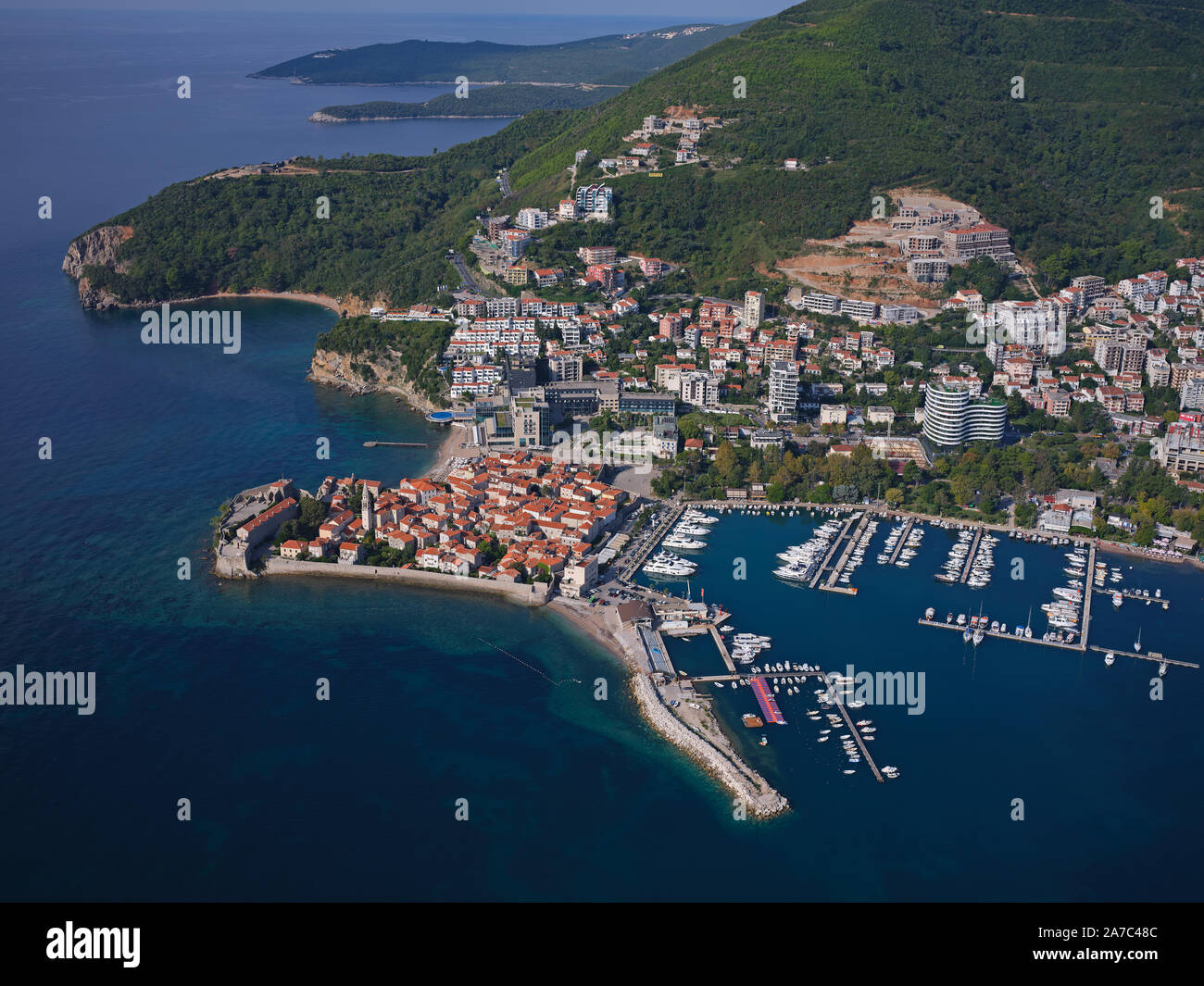 AERIAL VIEW. Medieval town on a rocky promontory. Budva, Montenegro. Stock Photo