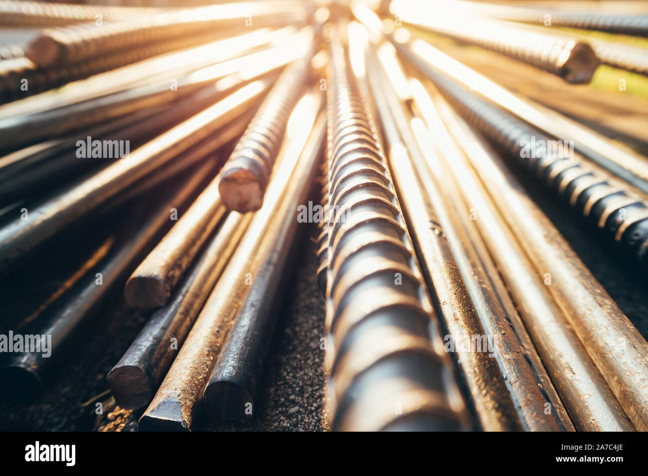 close up steel bar or steel reinforcement bar in the construction site with sunbeam in the morning, steel rods bars can use for reinforcing concrete. Stock Photo