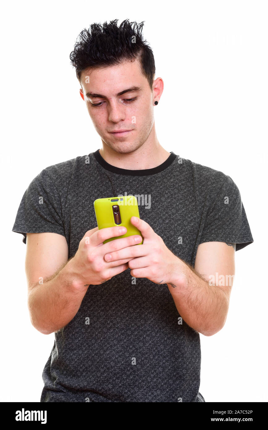 Studio shot of young handsome man isolated against white background ...