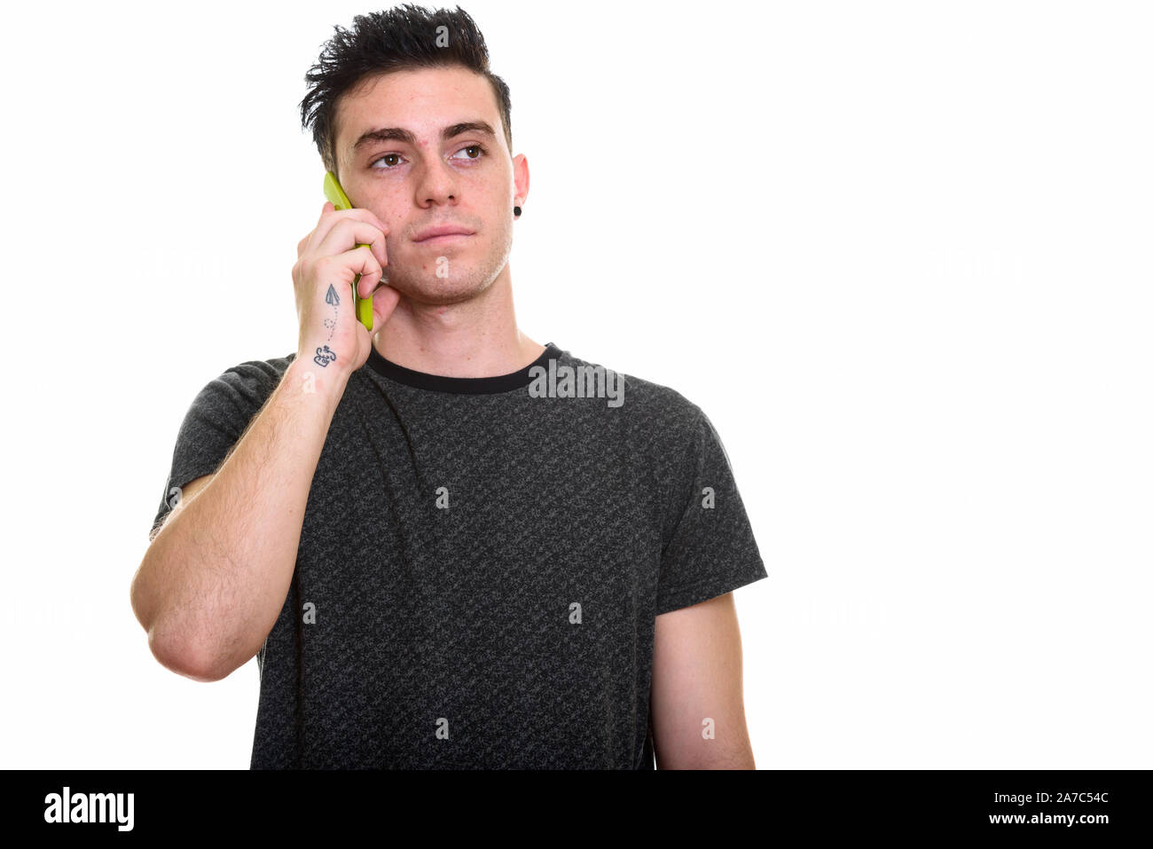 Studio shot of young handsome man isolated against white background ...