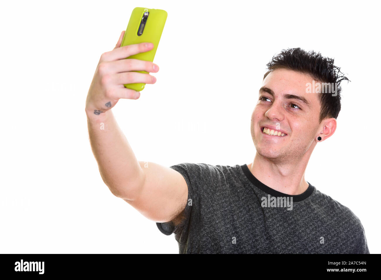 Studio shot of young handsome man isolated against white background ...