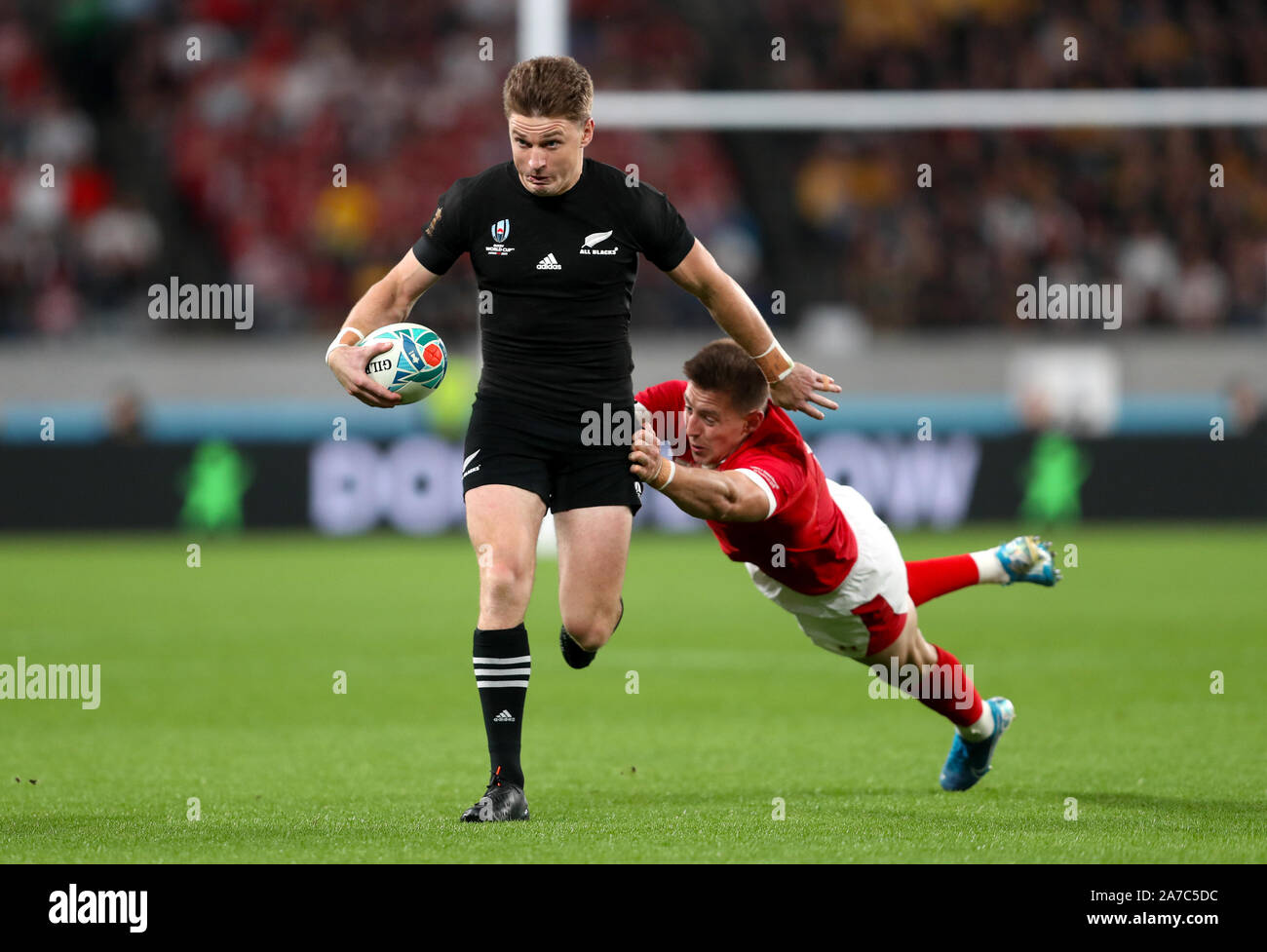 New Zealand s Beauden Barrett left is challenged by Wales Josh