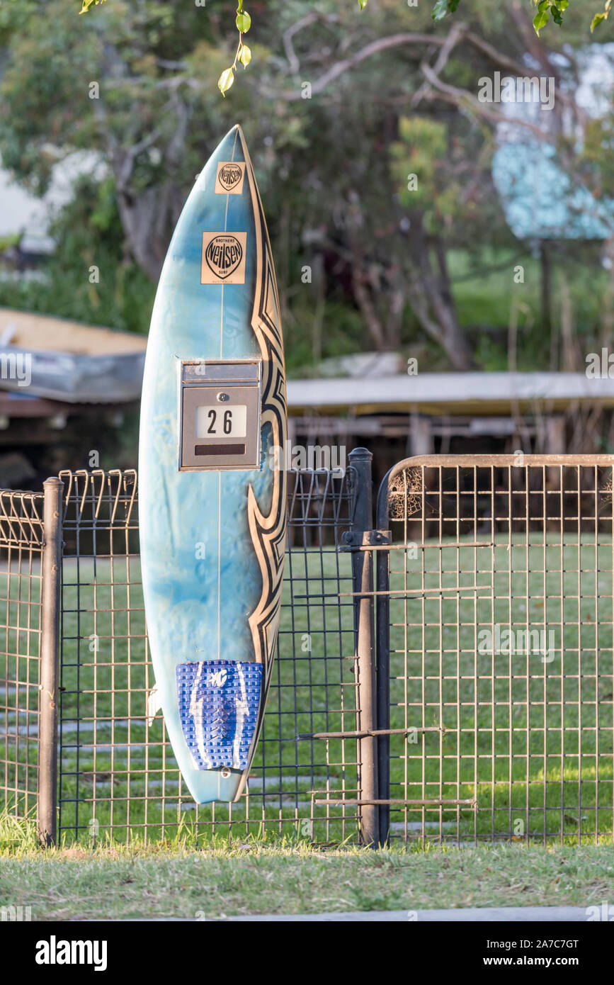 A letterbox fashioned from a converted upcycled surfboard attached to a