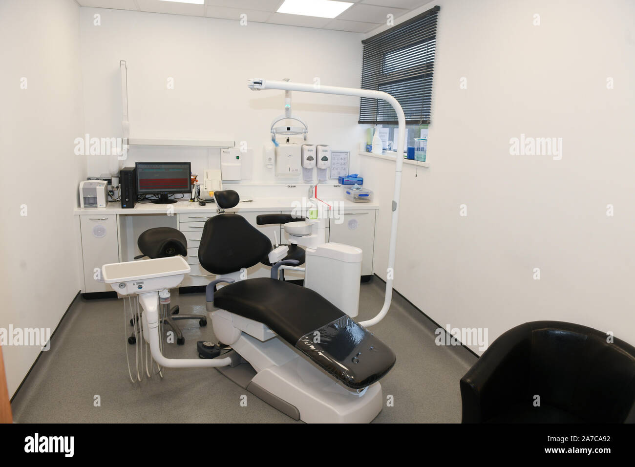 The inside of a typical dental practice in the UK showing the dentist chair and instruments. Stock Photo