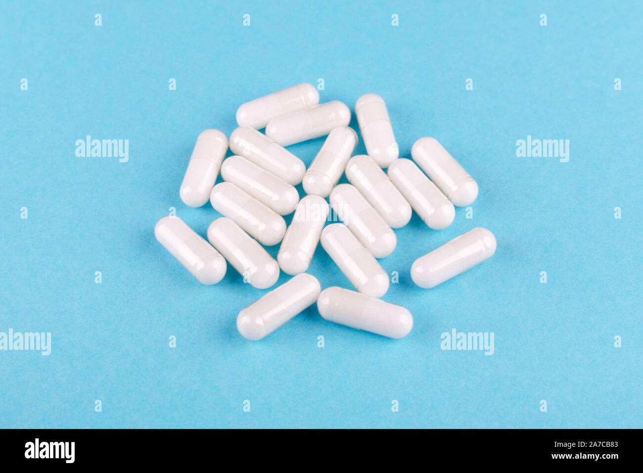food supplement capsules on blue background closeup Stock Photo