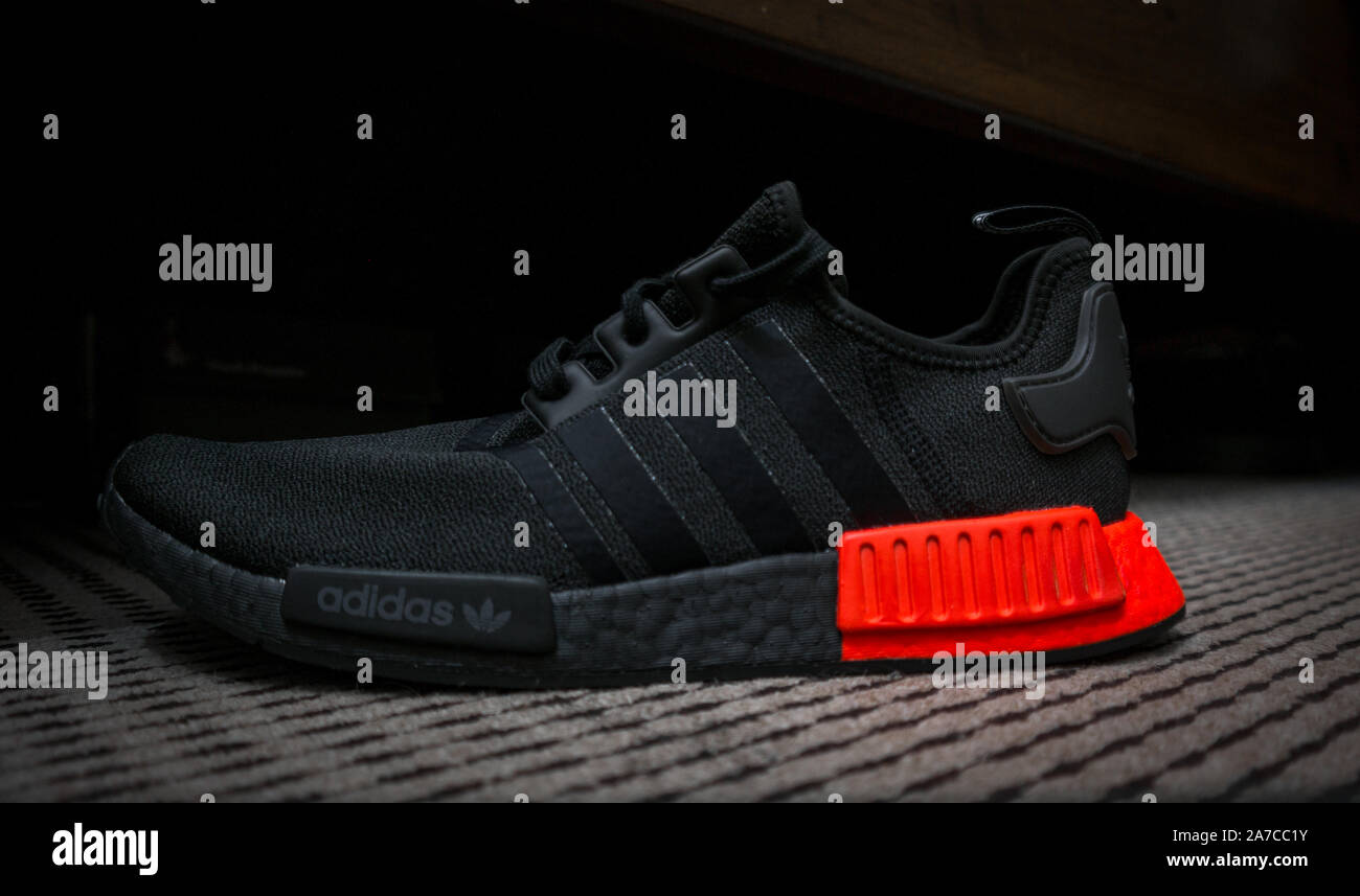 ADIDAS NMD sneakers ULTRA BOOST technology in all black with red accent - sports shoes Stock Alamy