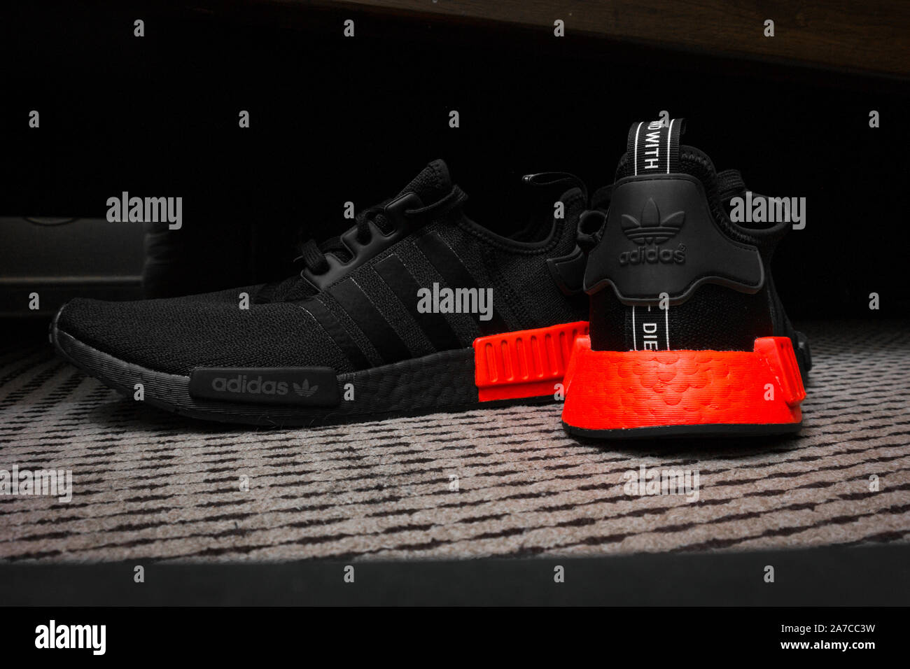 ADIDAS NMD sneakers with ULTRA BOOST technology in all black with red  accent - sports shoes Stock Photo - Alamy